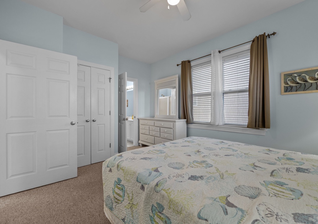 Drift off to sleep in this tranquil coastal bedroom where soft blues and ocean-themed bedding create your perfect seaside sanctuary.