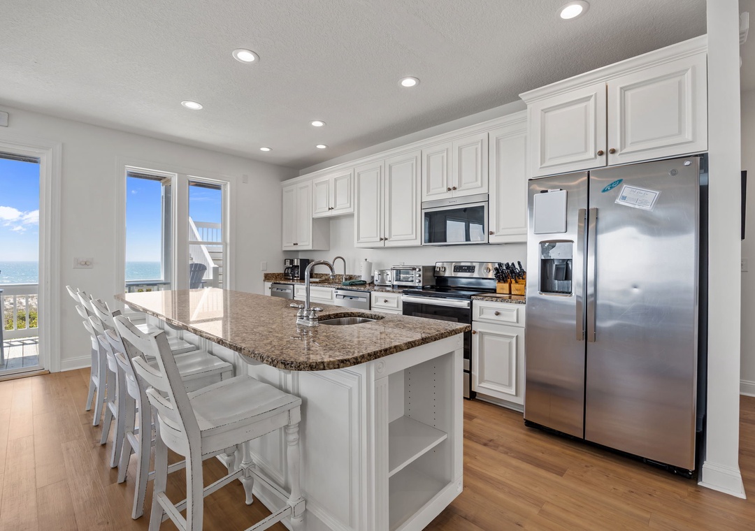 Your gourmet kitchen features granite counters, stainless appliances, and a breakfast bar where you can sip morning coffee while enjoying stunning ocean views.