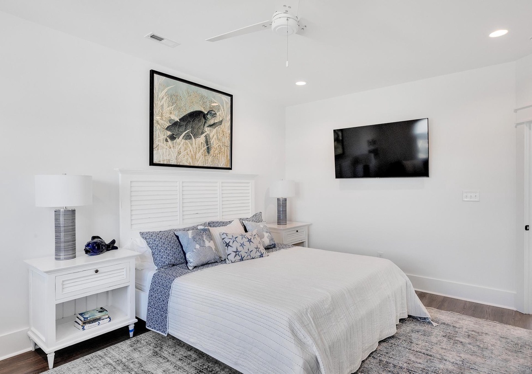 Sink into your plush bed under the ceiling fan, unwind with your favorite shows on the wall-mounted TV, and wake up refreshed in this bright, serene bedroom.