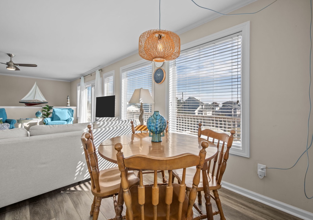 Gather around your warm wooden dining table while enjoying stunning city views through expansive windows that flood the space with natural light.