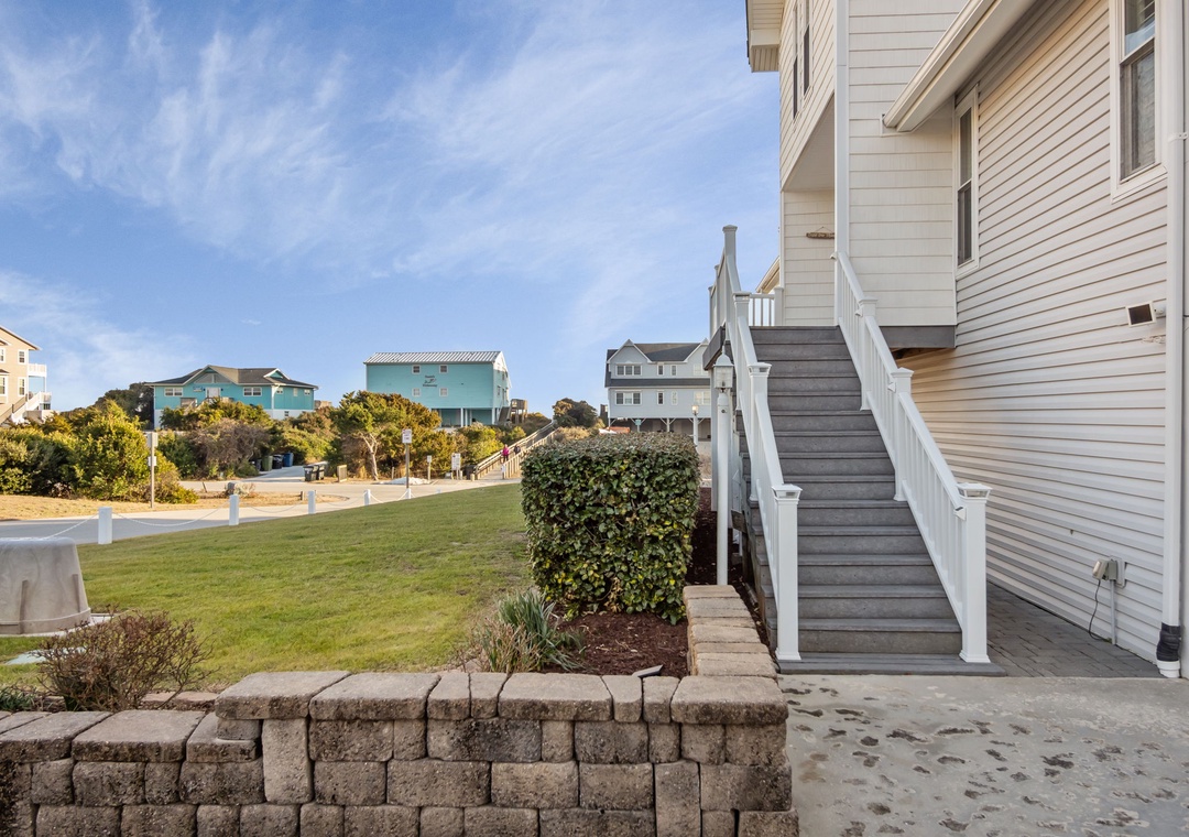 Coastal neighborhood setting with colorful beach houses and well-maintained landscaping creating a charming seaside community atmosphere.