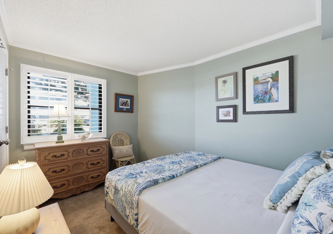 Relax in this serene coastal bedroom, where soft blues and crisp linens invite restful nights after your day exploring the area.