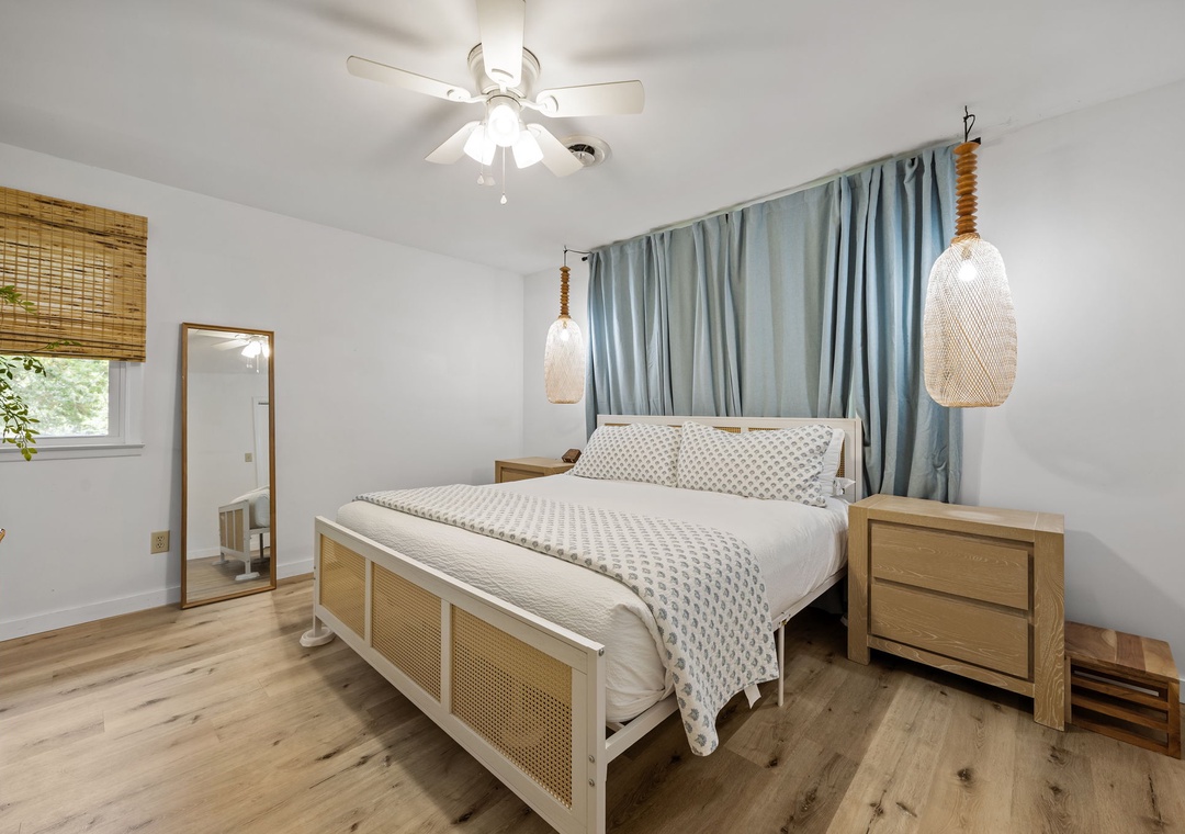 Drift off in your serene bedroom featuring a cozy bed, natural textures, and calming blue accents for peaceful nights.