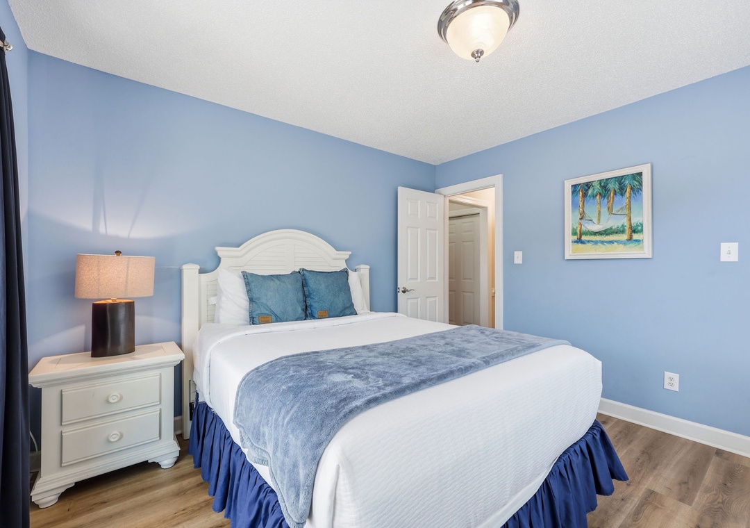 Sink into soft linens and coastal charm in this serene bedroom, where soothing blue tones and gentle lighting create your perfect retreat after a day of adventure.