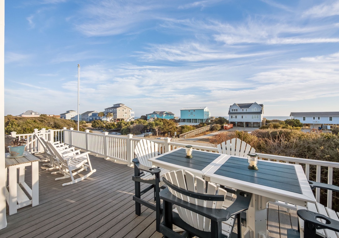 Spacious deck with comfortable seating where you can dine al fresco and unwind while taking in coastal views.