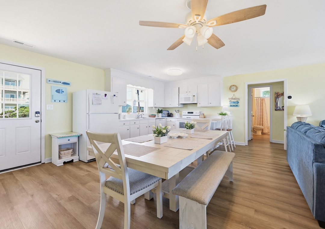 Gather around your spacious dining table with seating for everyone, opening to a fully equipped kitchen and relaxing living area—perfect for making vacation memories together.