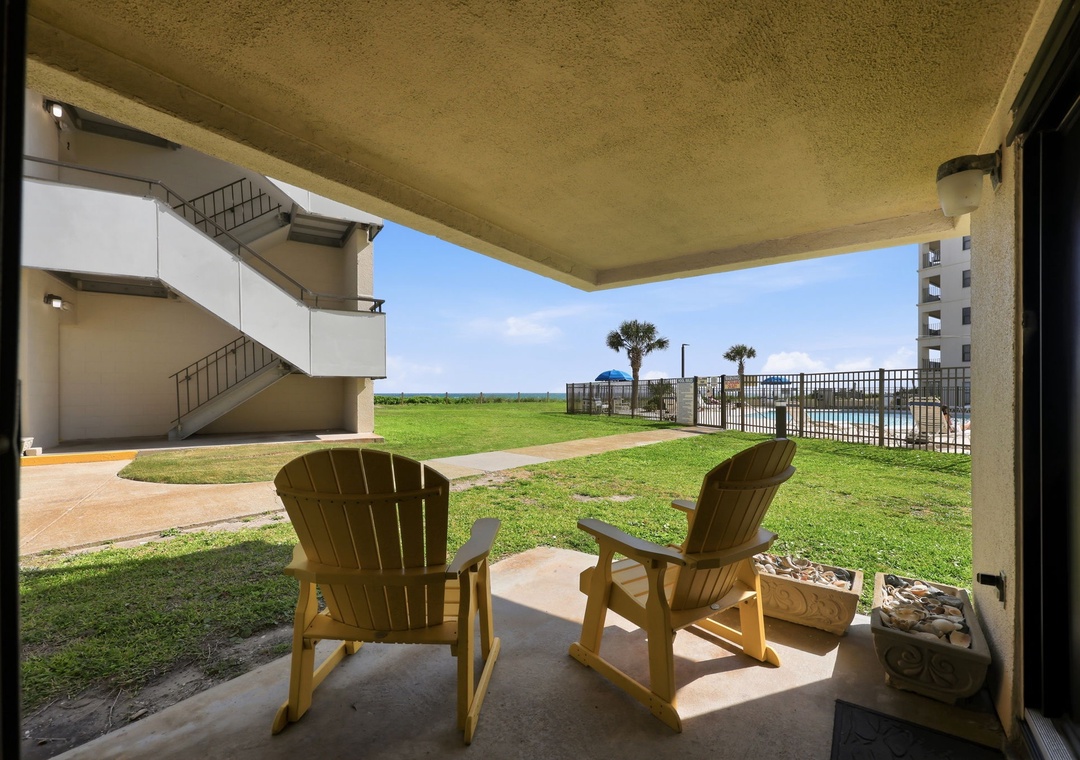 Relax in your own private patio chairs with direct views of lush lawn, swaying palms, and ocean beyond—perfect for morning coffee or sunset watching.