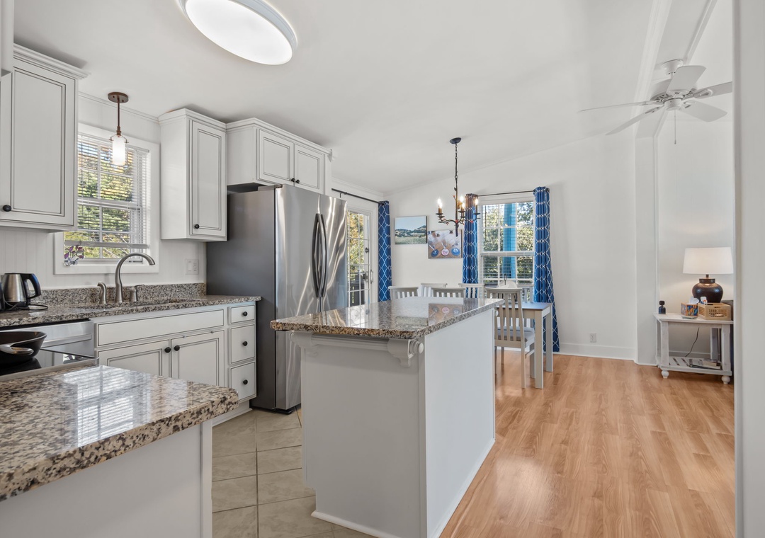 Your bright kitchen features granite countertops, stainless steel appliances, and flows seamlessly into the dining area.