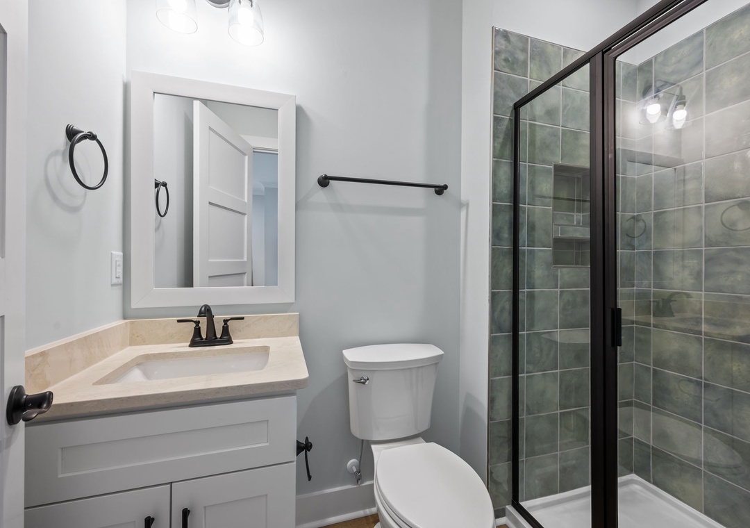 Step into your pristine bathroom featuring a luxurious glass shower, elegant vanity, and modern finishes for your comfort.