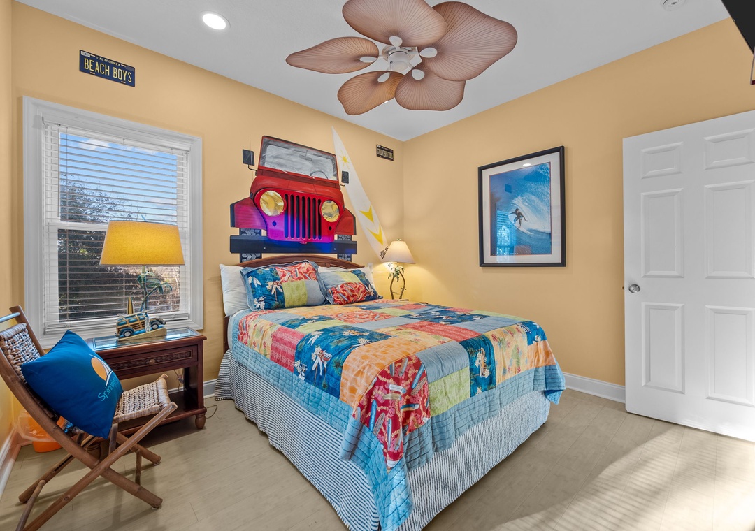 Your beach-themed bedroom features colorful surf bedding and fun tropical ceiling fan for dreamy seaside nights.