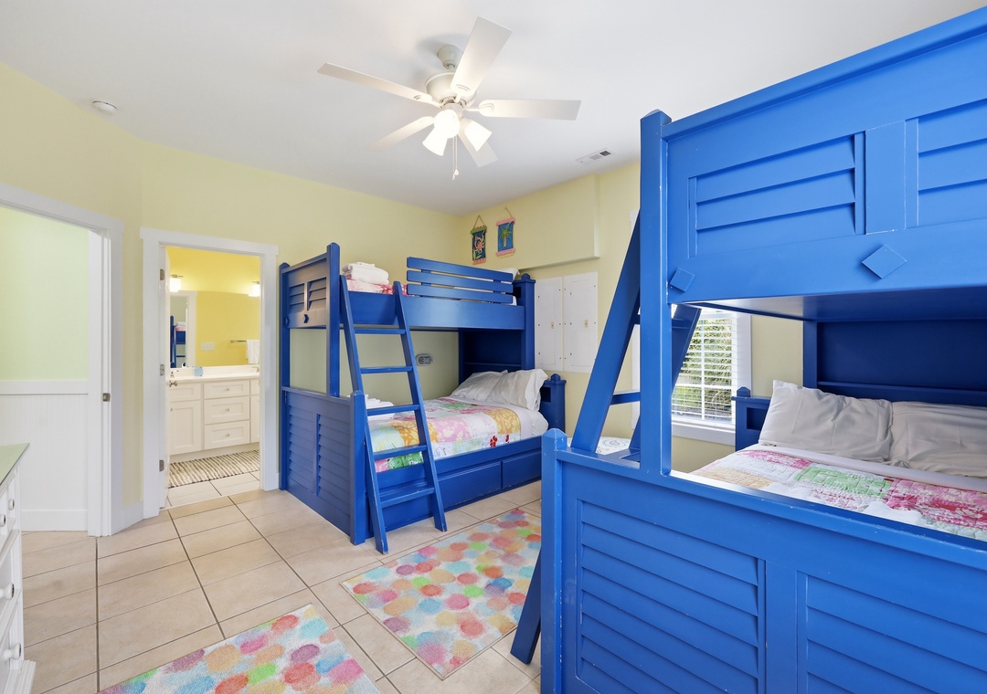 Your kids will love this cheerful bedroom with vibrant blue bunk beds, playful decor, and plenty of space for restful nights and fun mornings together.