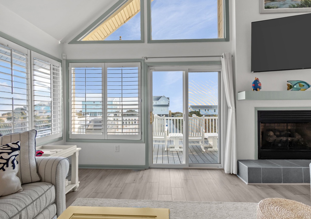 Relax in your bright living room with soaring ceilings, cozy fireplace, and sliding doors opening to your private balcony overlooking the neighborhood.
