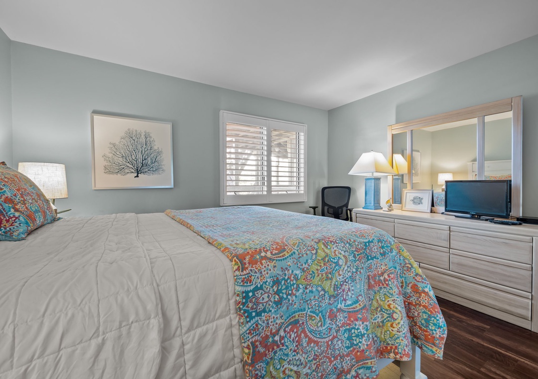Rest peacefully in your coastal-inspired bedroom, where soft blue walls and vibrant linens create the perfect sanctuary for rejuvenating sleep.