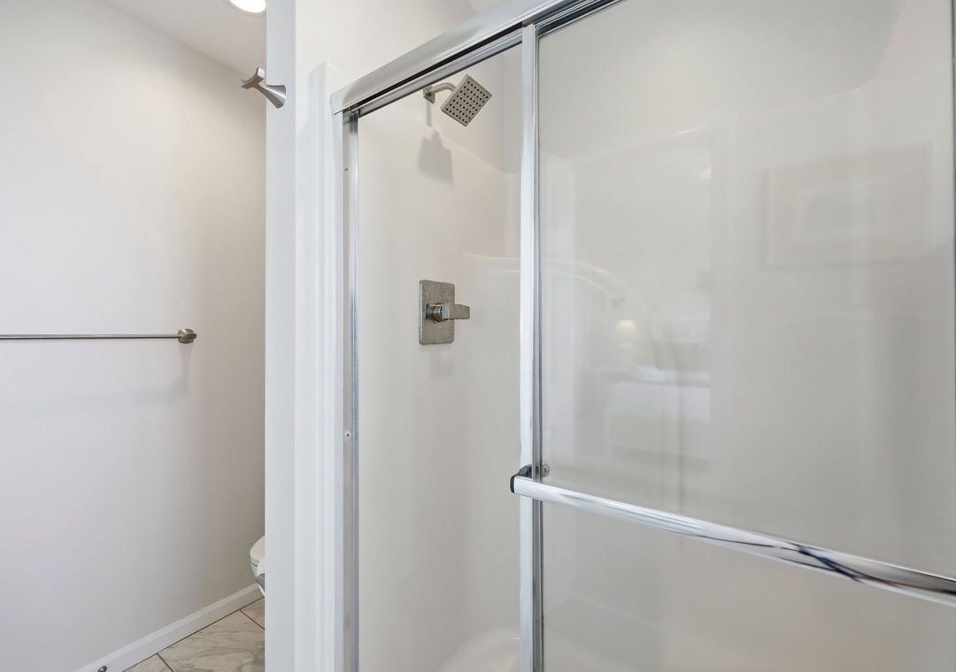 Step into your private glass-enclosed shower with rainfall showerhead—perfect for refreshing after a day of adventure or relaxing before bed.