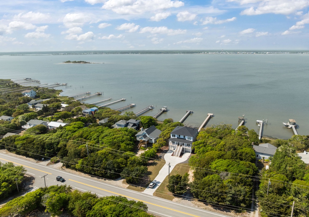 Aerial view of waterfront property showcasing the beautiful bay location with private dock access and peaceful coastal setting.