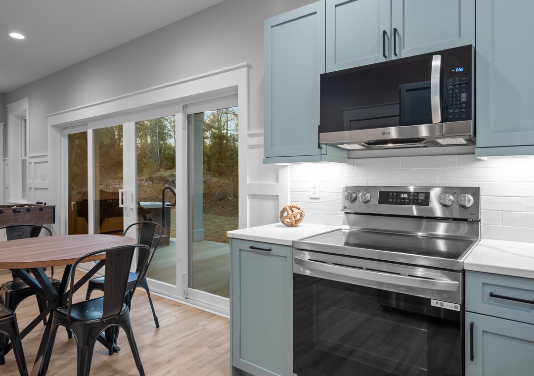 2nd Kitchen in game room with window that opens to the pool bar with seating!