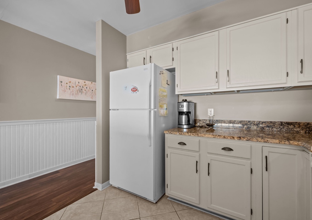 Your fully equipped kitchen awaits with granite countertops, white appliances, and plenty of cabinet space for all your culinary adventures.