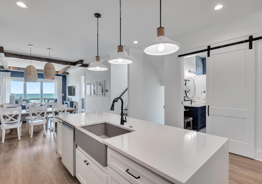 Picture yourself preparing meals at this stylish kitchen island, where coastal light fills the open space and those dreamy ocean views are just steps away, inviting you to unwind in your beachside retreat.