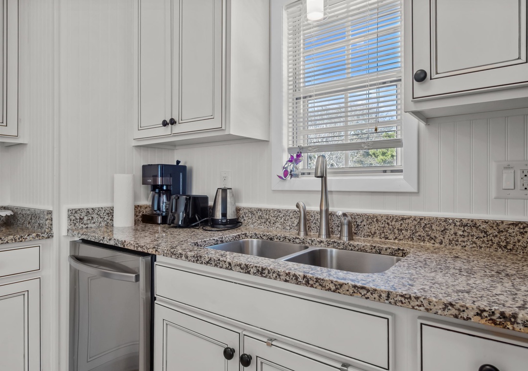 Your fully equipped kitchen features granite counters, modern appliances, and a coffee maker ready for your morning routine.