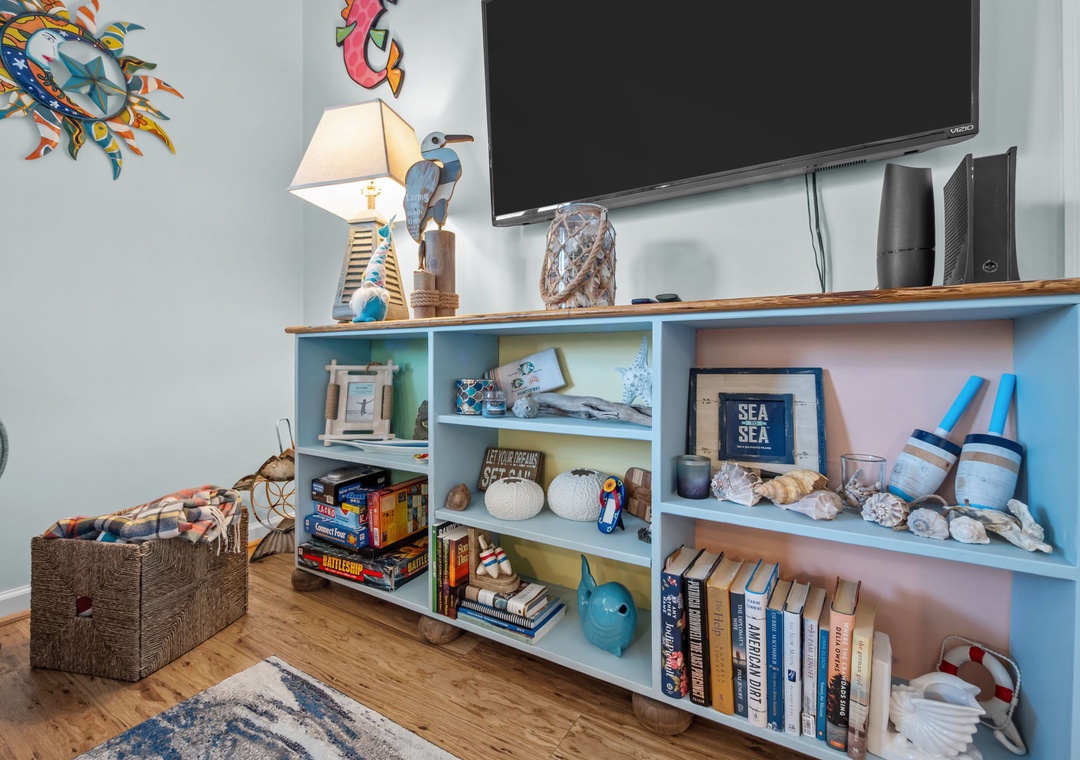 Cozy up in your charming living space with nautical decor, games, and books for perfect evening entertainment.