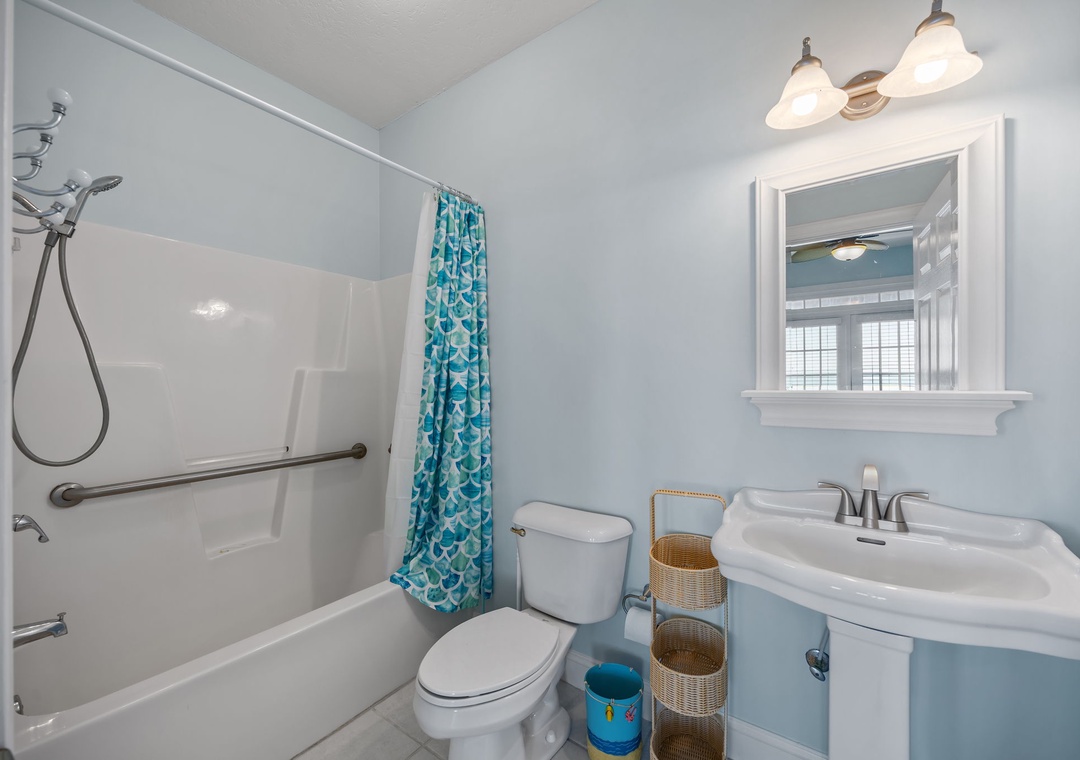 Fresh up in your private bathroom with modern fixtures, soothing blue tones, and thoughtful accessibility features for ultimate comfort.