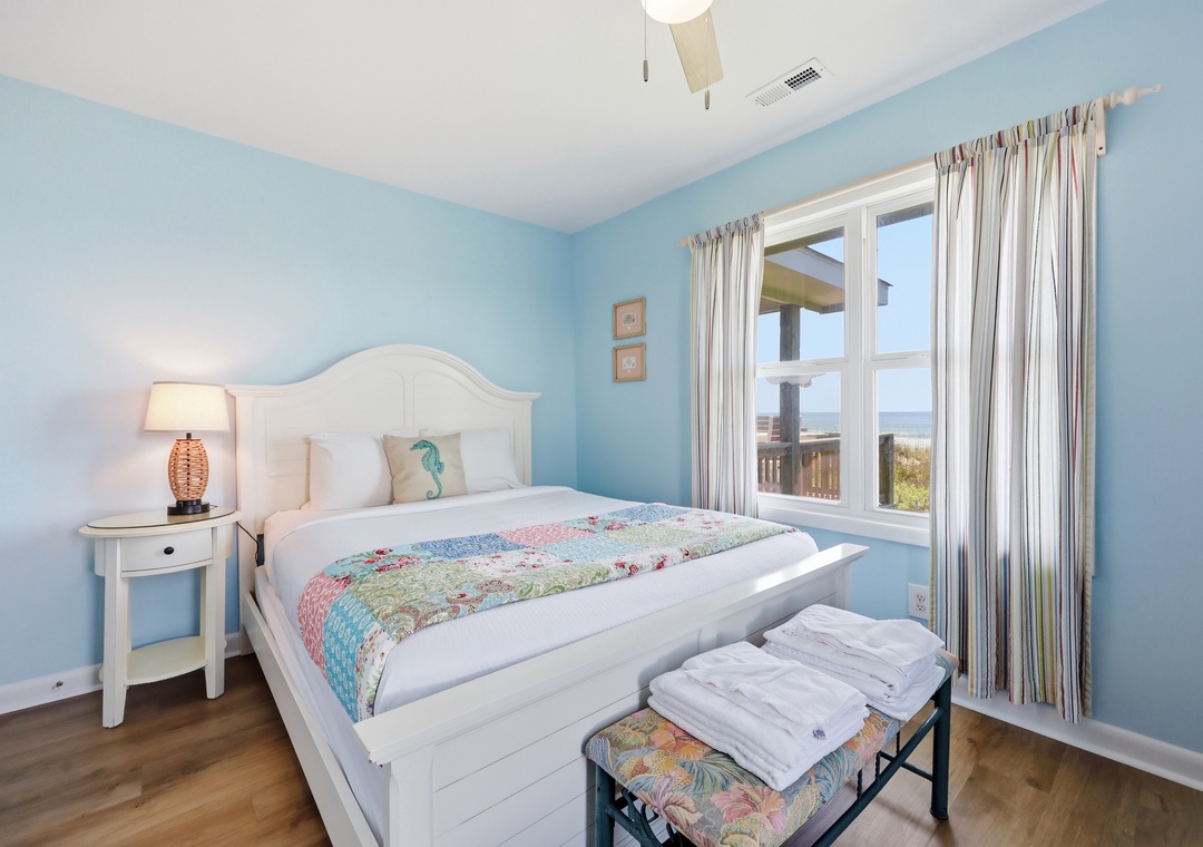 Drift off in soft coastal blues with a plush bed and peek at ocean views just outside your window. Your beach getaway begins here.