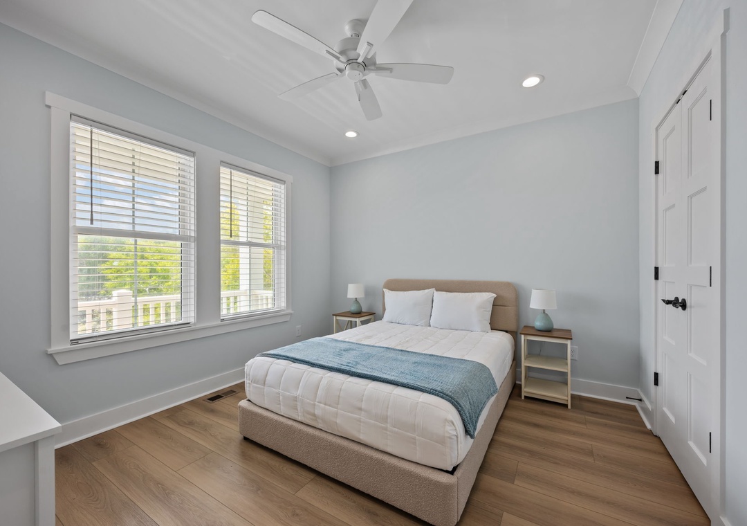 Your serene bedroom features soft blue walls and coastal decor, creating the perfect retreat after busy beach days.