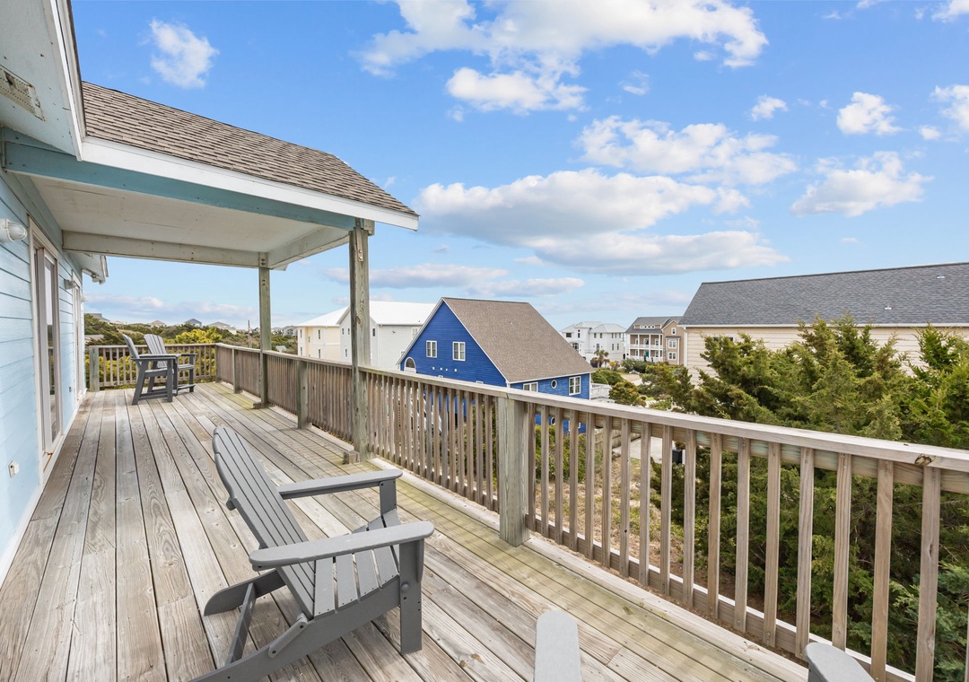 Spacious deck with comfortable seating where you can enjoy morning coffee while taking in the neighborhood views.
