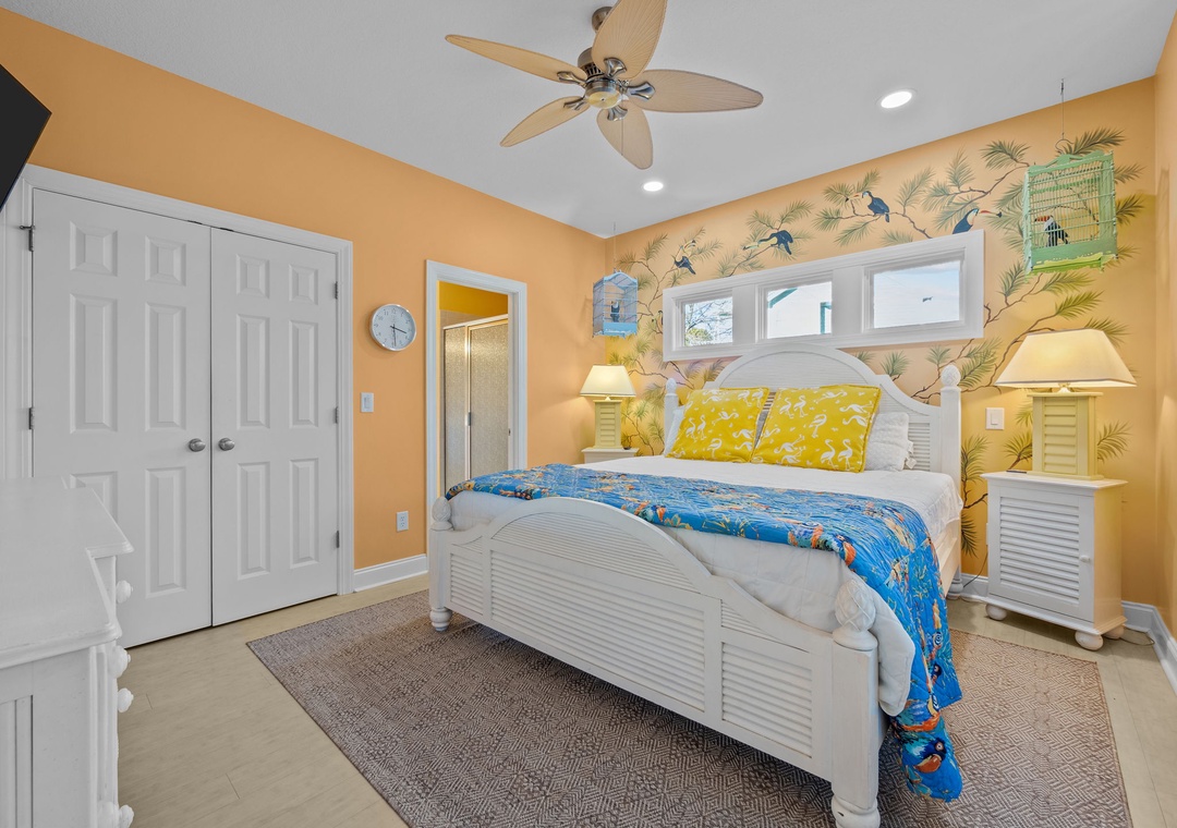 Drift into tropical dreams in your cheerful coastal bedroom with vibrant island-themed décor and comfortable white furnishings.