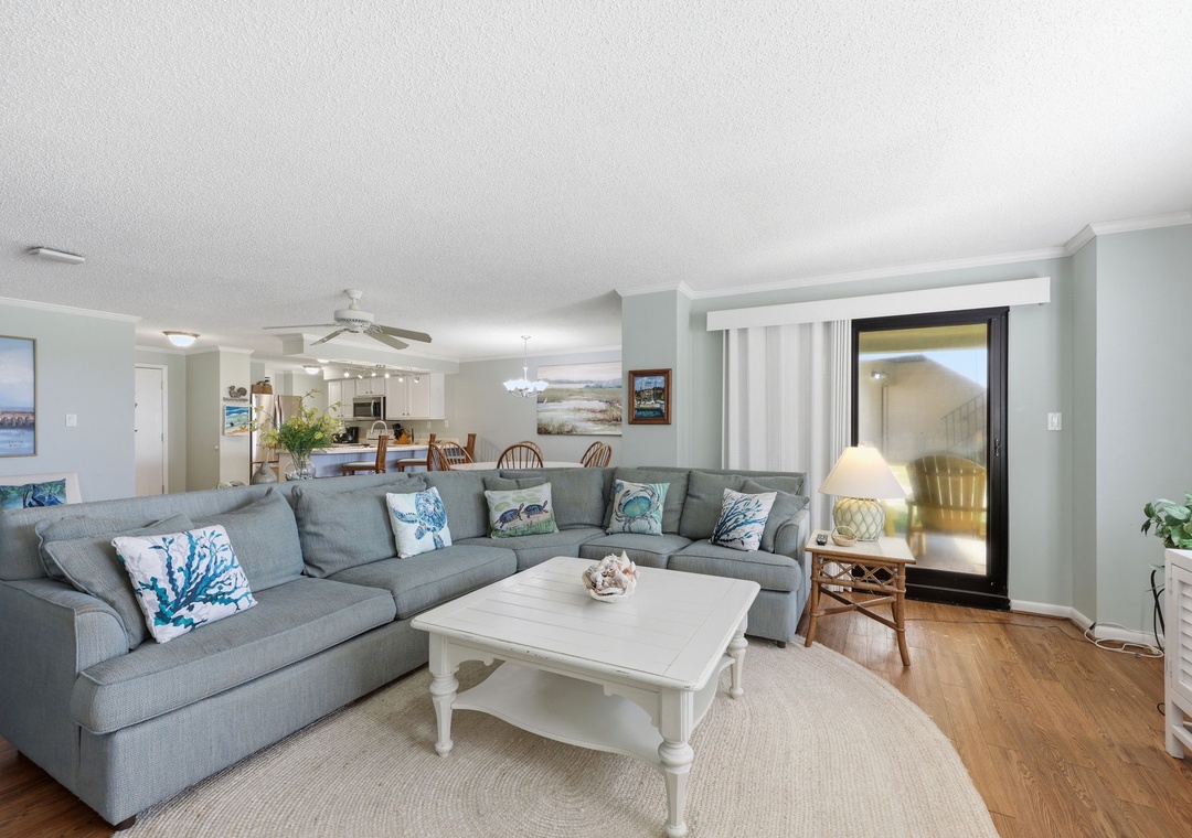 Relax in this bright, spacious living area where coastal charm meets comfort. The plush sectional and open layout invite you to unwind after a day of exploring nearby beaches.
