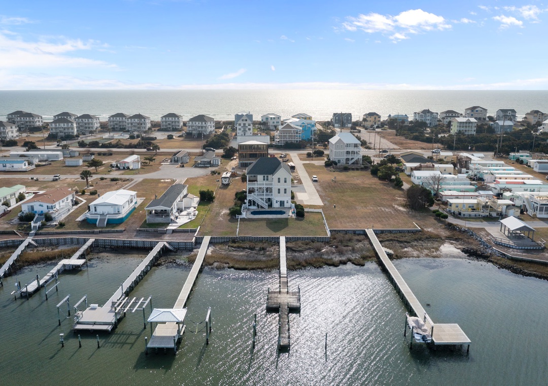Coastal community with waterfront homes, private marina, and beach access creating the perfect seaside retreat destination.