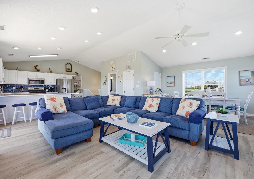 Sink into the plush blue sectional with a book, or unwind at the breakfast bar where coffee and conversation flow. Bright windows and coastal touches make you feel at home instantly.