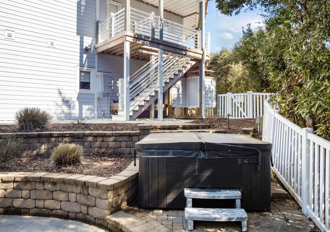 Soak your cares away in your private hot tub, surrounded by beautiful stone landscaping and peaceful outdoor space.