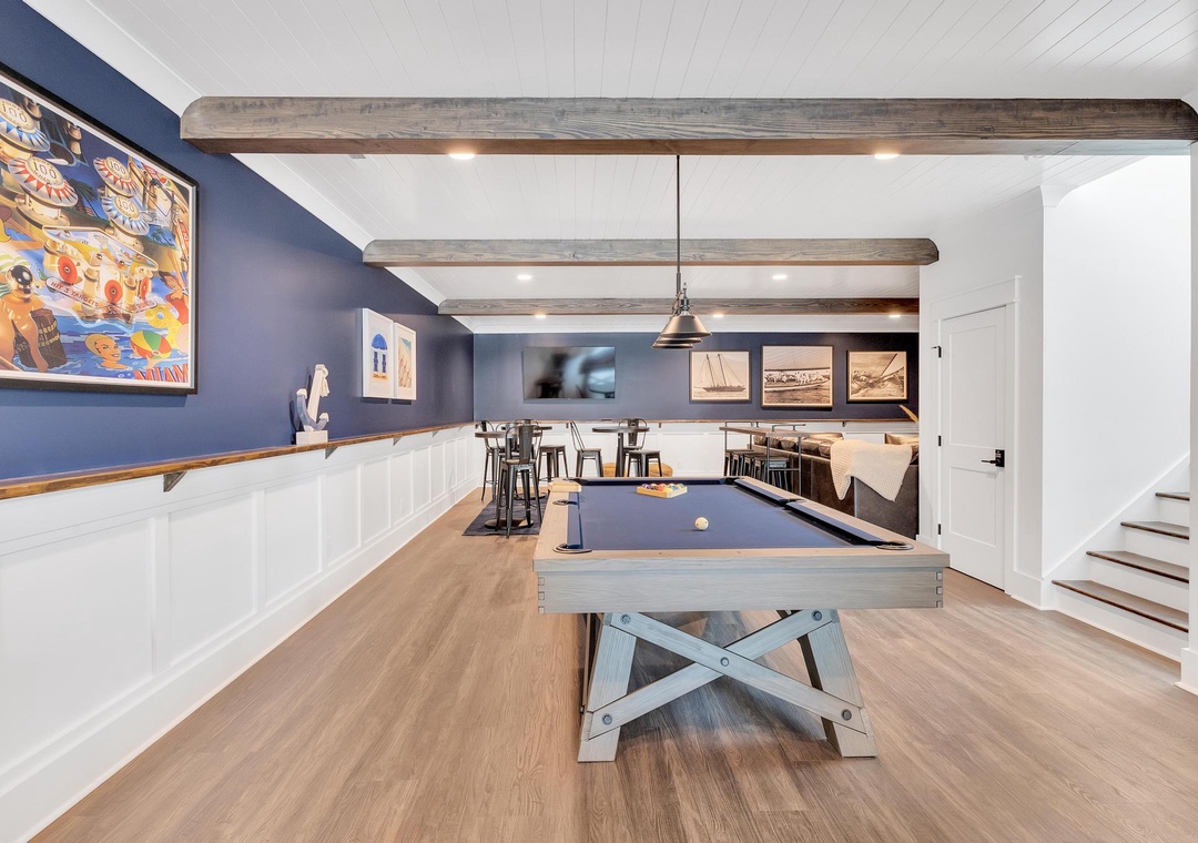 Challenge your friends to a game of pool in this stylish game room, complete with a pub-height table and coastal charm—perfect for your downtime and fun-filled evenings.