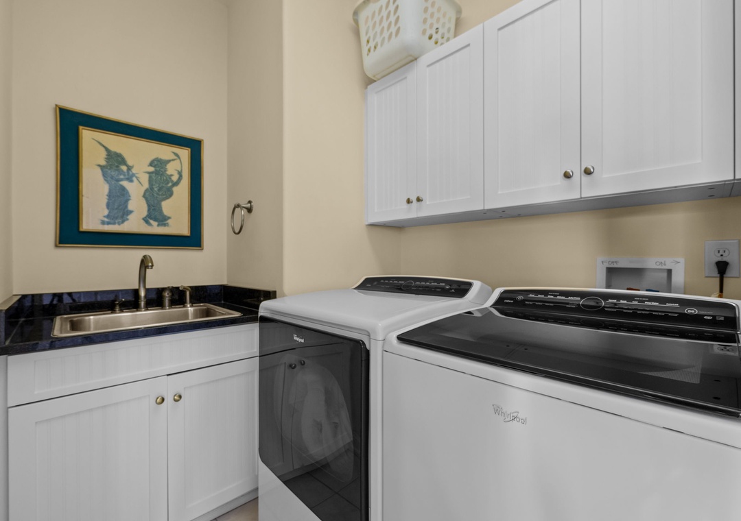 Your dedicated laundry room features modern washer and dryer with convenient sink and storage for effortless care of your belongings.