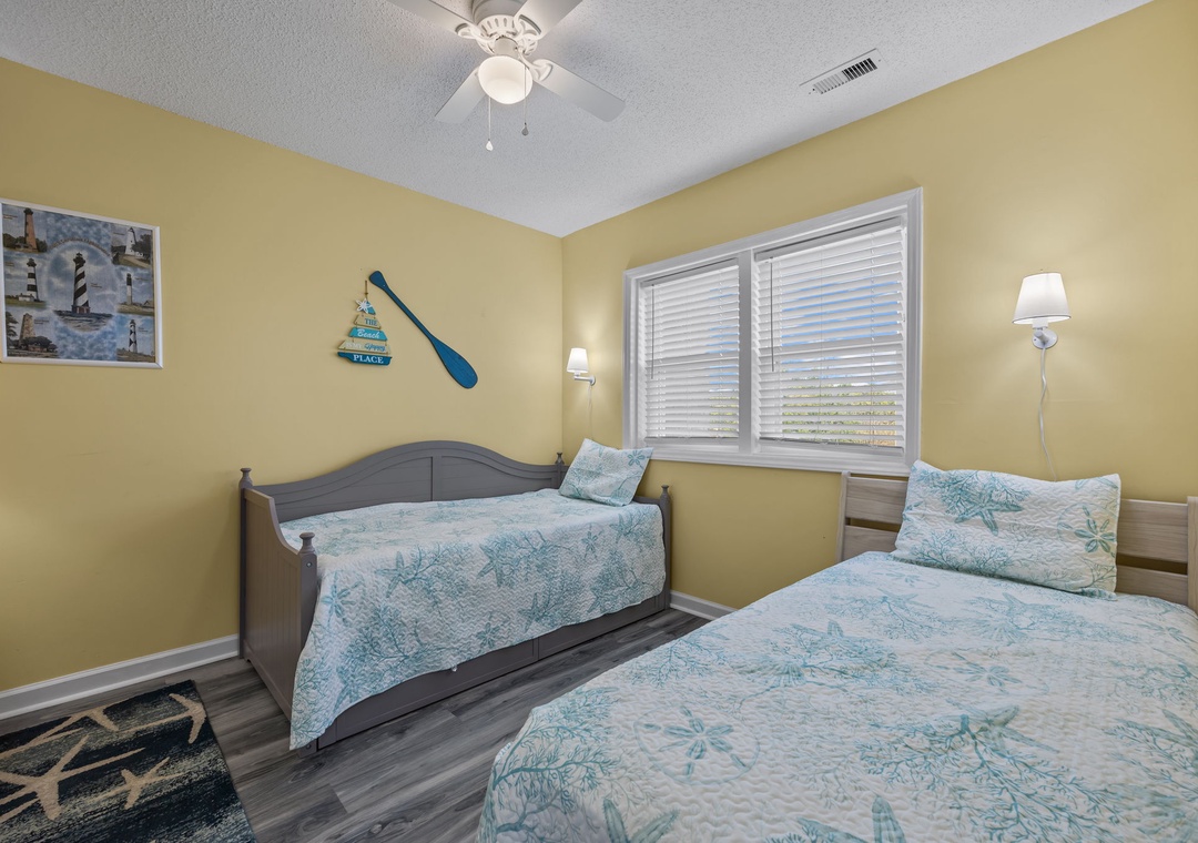Drift off to sleep in your coastal-themed bedroom with twin beds and cheerful nautical touches that capture beach vibes.