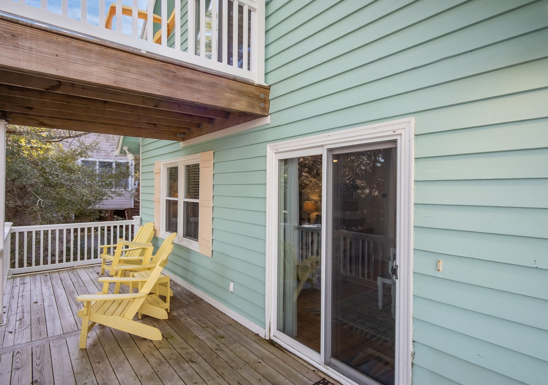 Step out onto your private deck with cheerful yellow Adirondack chairs, perfect for morning coffee or evening relaxation under the covered porch.