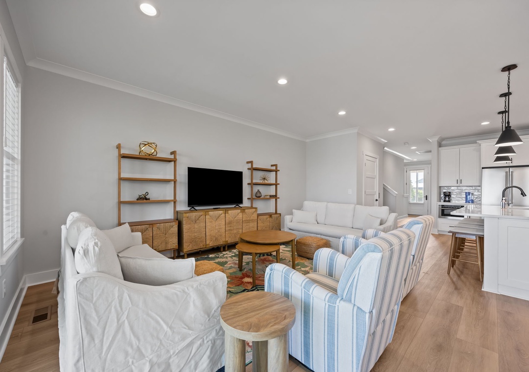 Relax in your bright, open living space with modern furnishings, entertainment center, and seamless flow to the fully-equipped kitchen.
