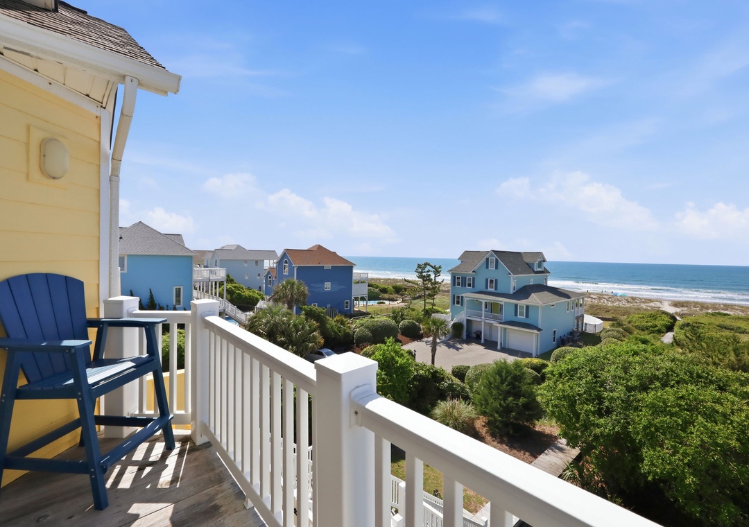 Coastal beach town with colorful homes, lush vegetation, and direct ocean access, offering guests a serene seaside escape surrounded by natural beauty and coastal charm.