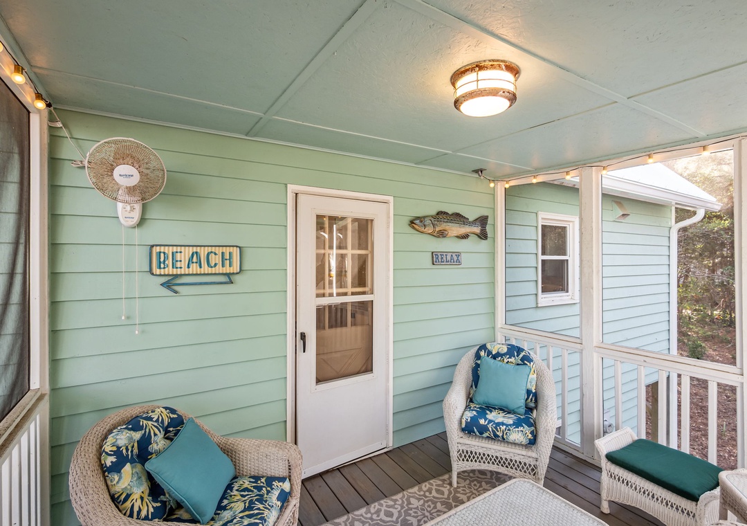 Unwind on your private covered porch with comfortable wicker seating and coastal charm—perfect for morning coffee or evening relaxation.