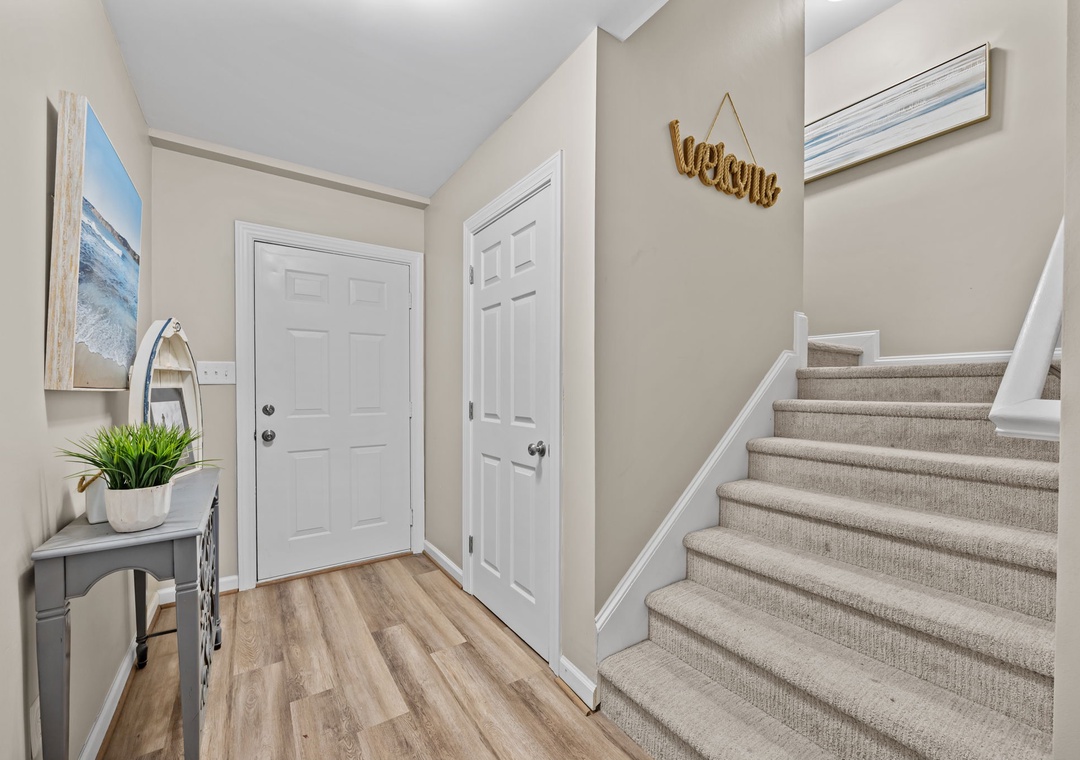 Step into your welcoming entryway, where coastal artwork and warm touches create an instantly relaxing atmosphere.
