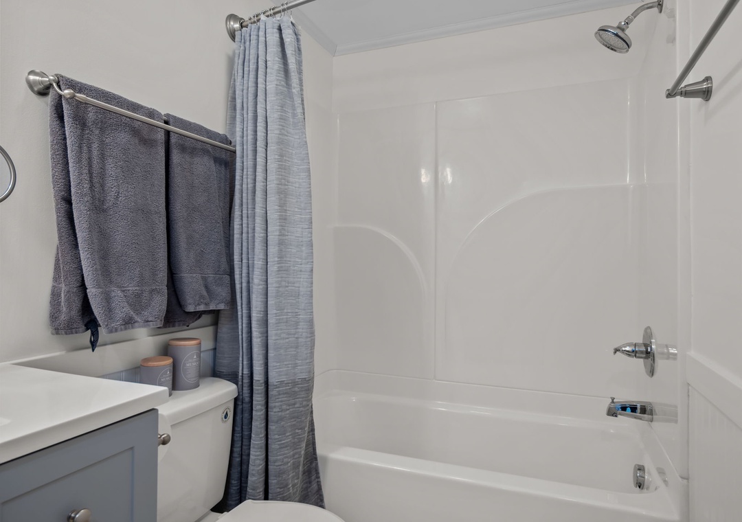 Refresh after your adventures in this clean, modern bathroom with plush towels and a spacious tub-shower combo.