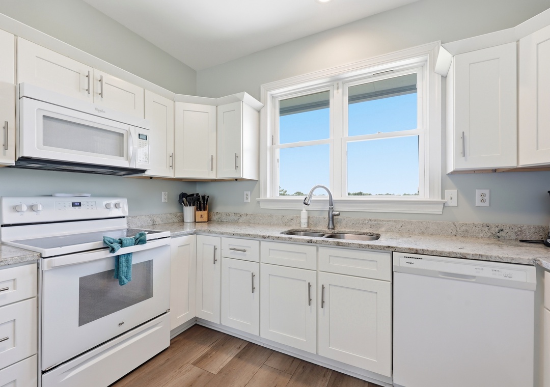 Your bright, fully-equipped kitchen offers everything you need to prepare delicious meals, with granite countertops, modern appliances, and natural light streaming through the windows.