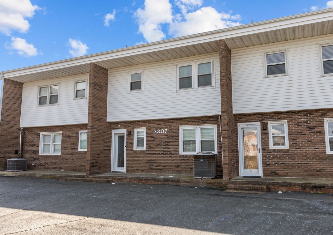 Spacious brick and vinyl siding building with multiple units offering comfortable accommodations in a convenient location.