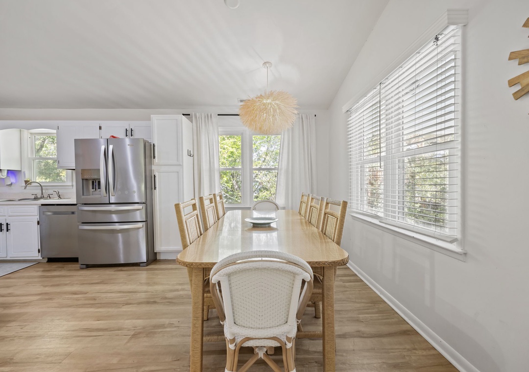 Gather around this beautiful dining table where your group can enjoy meals together in bright, airy comfort with natural light streaming through.
