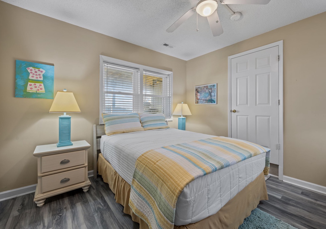 Drift into peaceful dreams in this cozy bedroom with soft coastal colors, comfortable bedding, and gentle natural light filtering through.