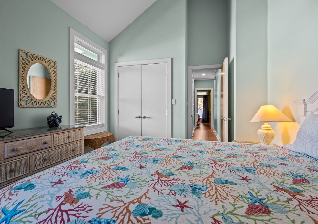 Drift off in your peaceful bedroom with ocean-themed bedding and soft seafoam walls that create a calming coastal retreat.