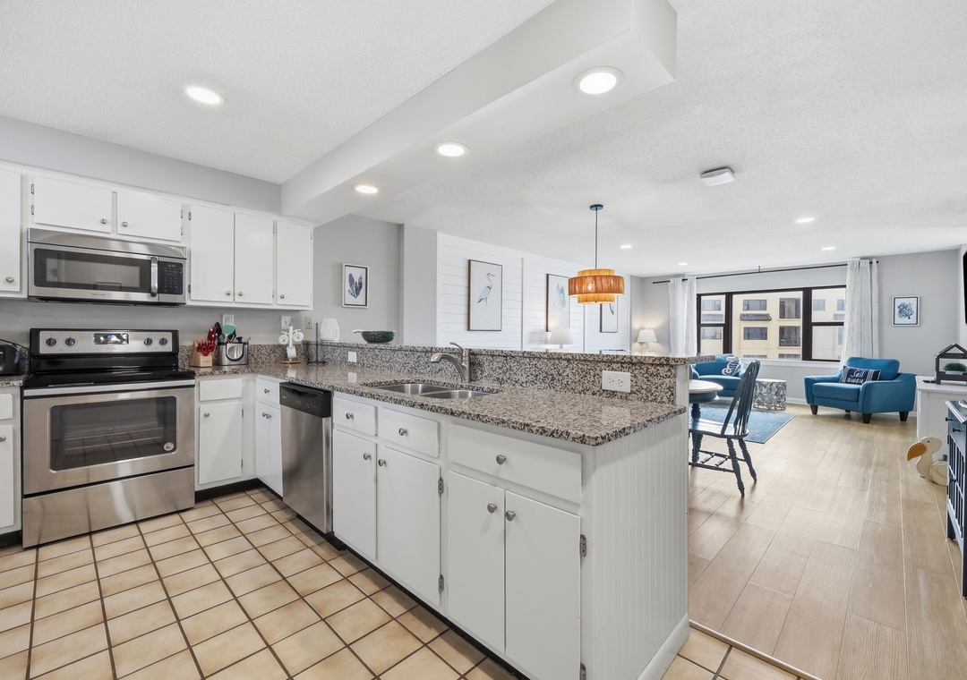 Bright open-concept space where your fully-equipped kitchen flows seamlessly into the living area—perfect for cooking, relaxing, and soaking in natural light.