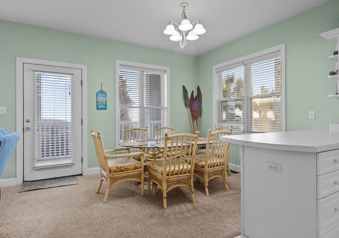 Gather around your coastal-style dining table in this bright, inviting space with soothing mint walls and plenty of natural light.