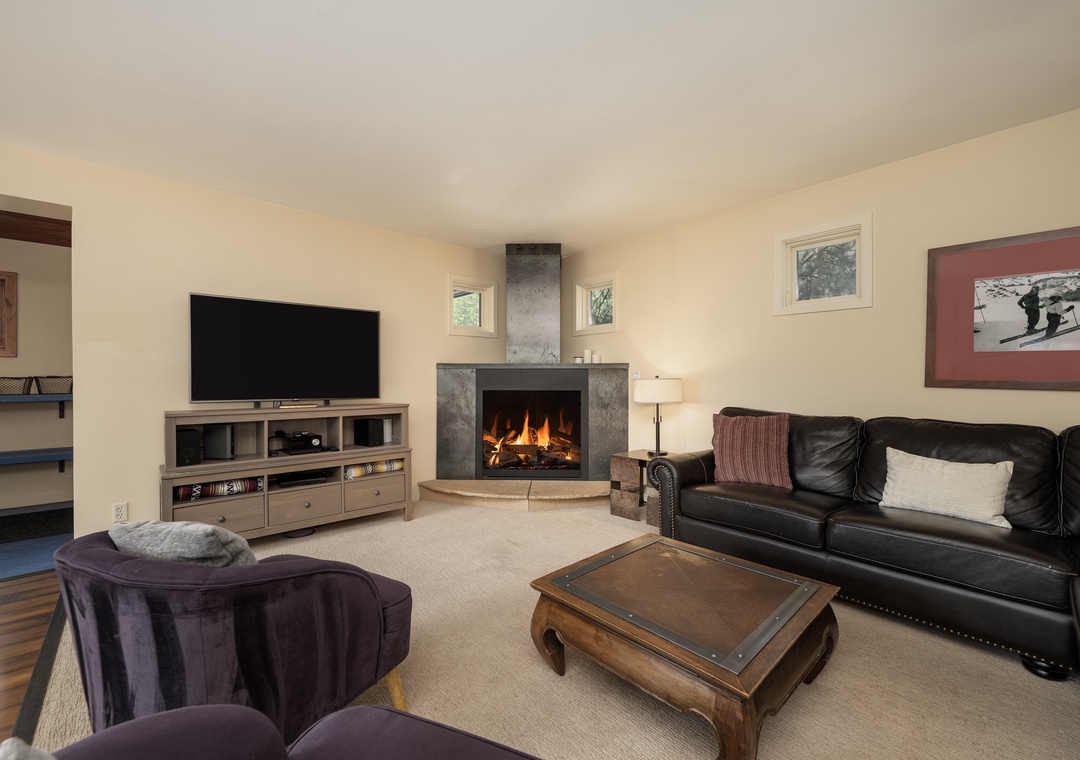 Sink into plush seating by your crackling fireplace, where cozy evenings unfold with your favorite shows on the large TV.